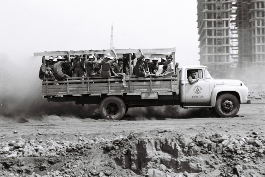Figure 2. Truck carrying construction workers near the future National Congress building, 1959. (Photo: Mário Fontenelle) Accessed from: https://memorialdademocracia.com.br/card/construcao-de-brasilia